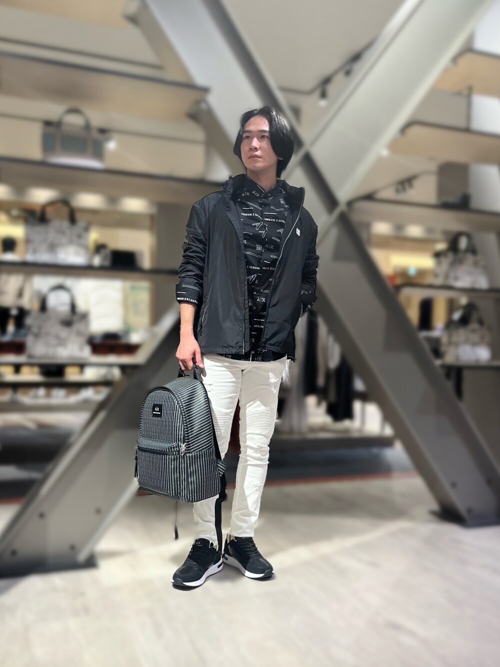 ブラック系のナイロンジャケット、ブラック系のシャツ/ブラウス、ホワイト系のデニムパンツを着用したメンズの秋コーディネートの1枚目の写真