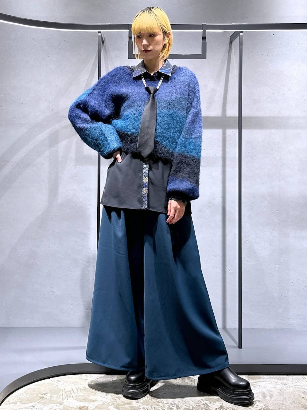 ブラック系のネクタイ、ブルー系のその他パンツ、ブラック系のブーツを着用したレディースの冬コーディネートの1枚目の写真