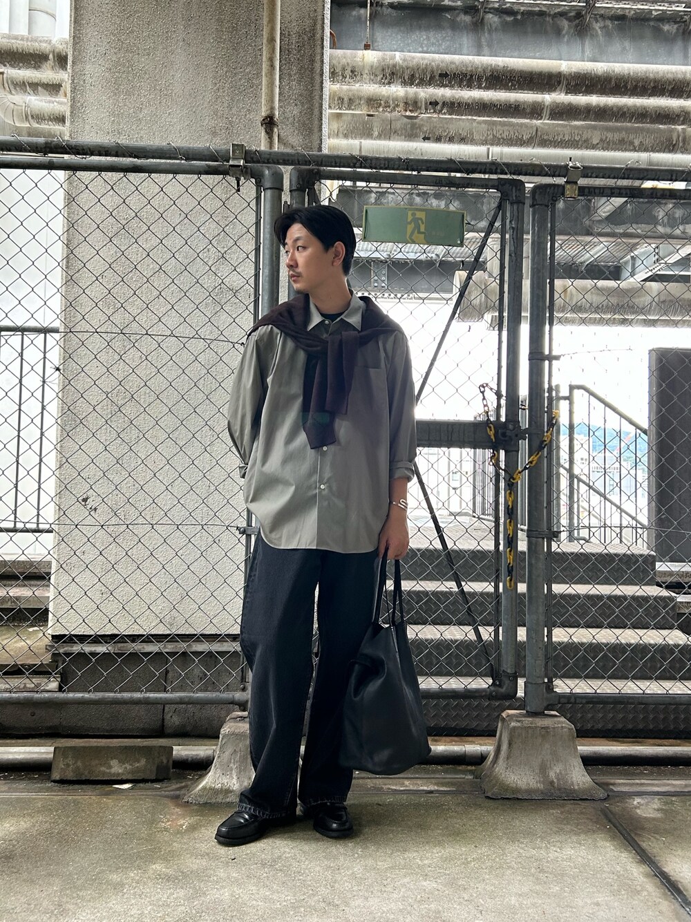 グリーン系のシャツ/ブラウス、ブラウン系のニット/セーター、ブラック系のデニムパンツを着用したメンズの秋コーディネートの1枚目の写真