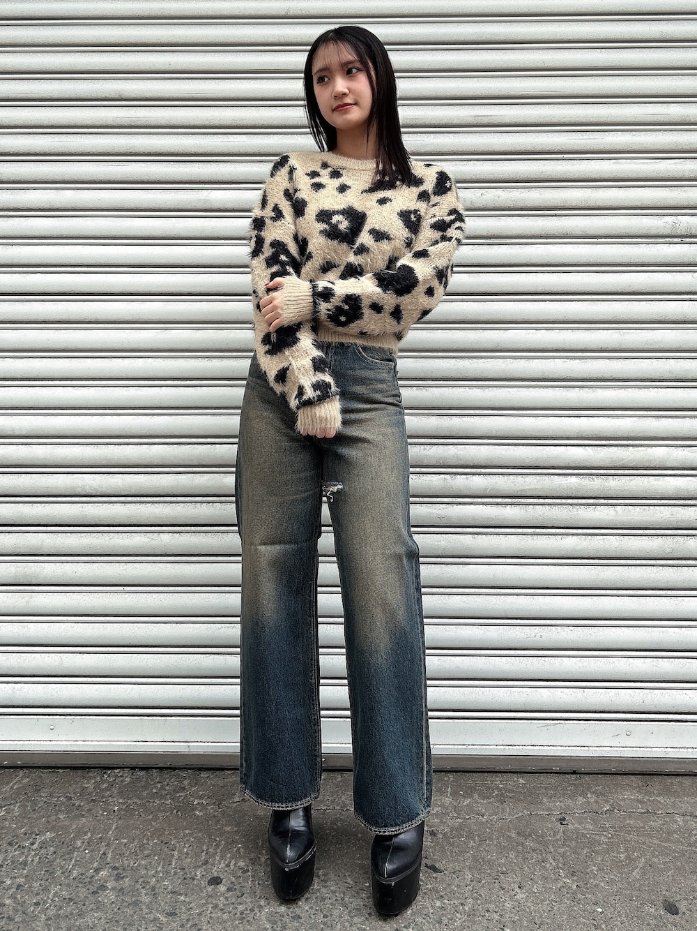 ホワイト系のニット/セーター、ブルー系のデニムパンツ、ブラック系のブーツを着用したレディースの冬コーディネートの1枚目の写真