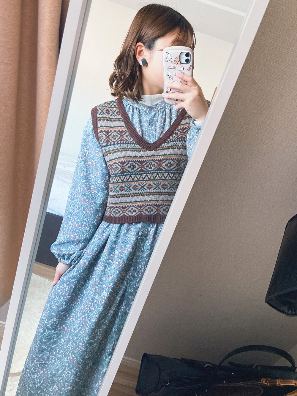 ブルー系のワンピース/ドレス、ブラウン系のベスト、ホワイト系のニット/セーターを着用したレディースの秋コーディネートの1枚目の写真