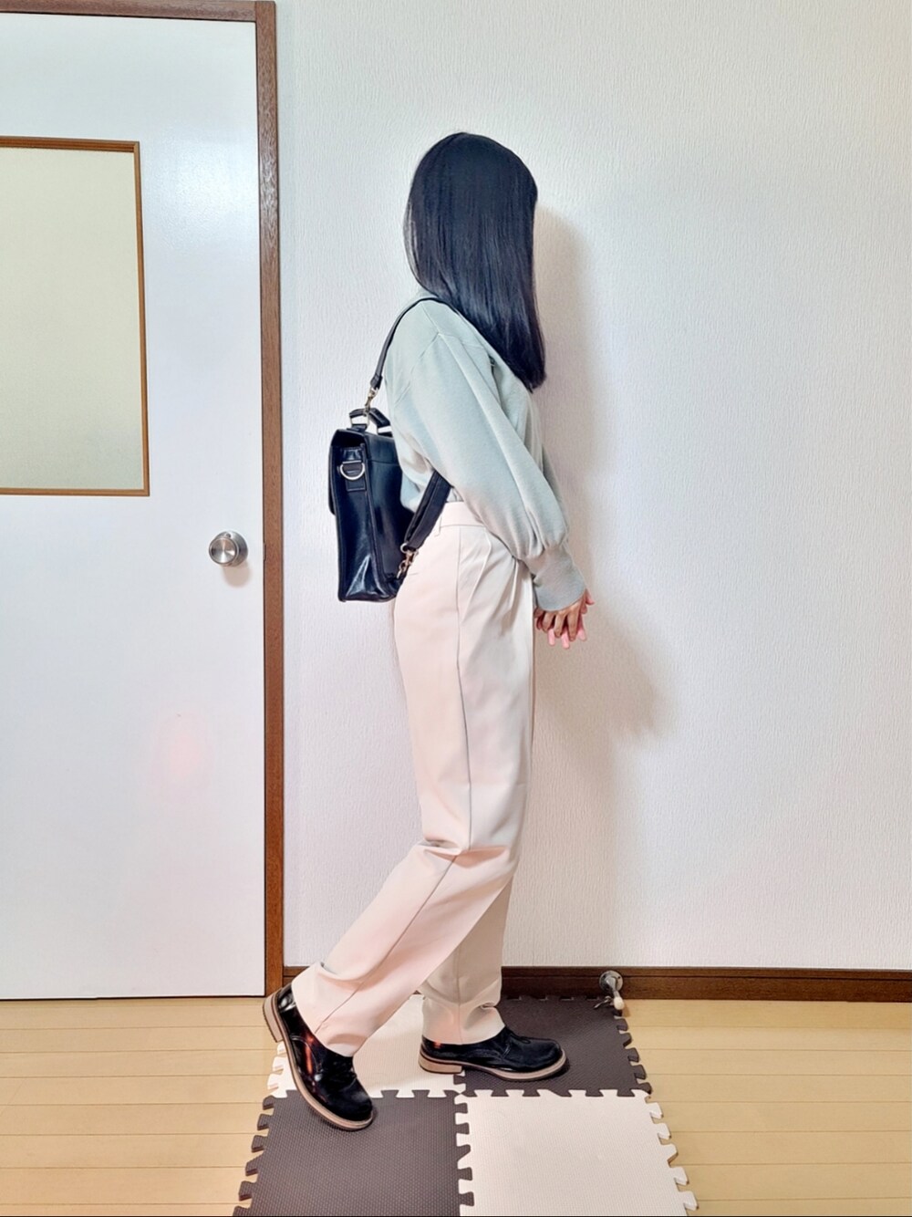 ベージュ系のダウンジャケット/コート、ホワイト系のその他パンツ、ブラック系のドレスシューズを着用したレディースの冬コーディネートの2枚目の写真