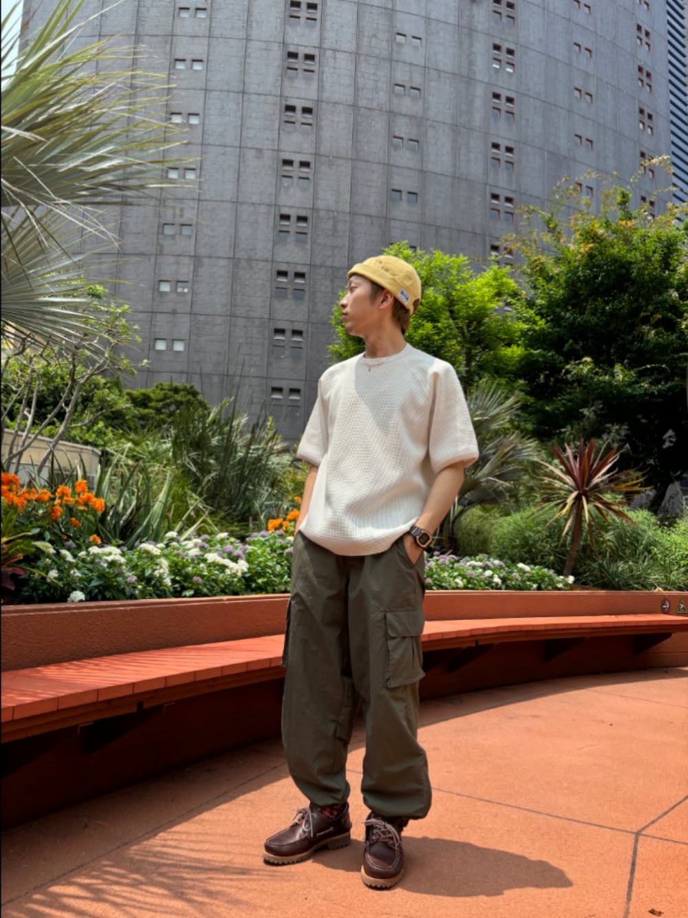 Cream waffle-knit T-shirt styled with washed olive cargo pants