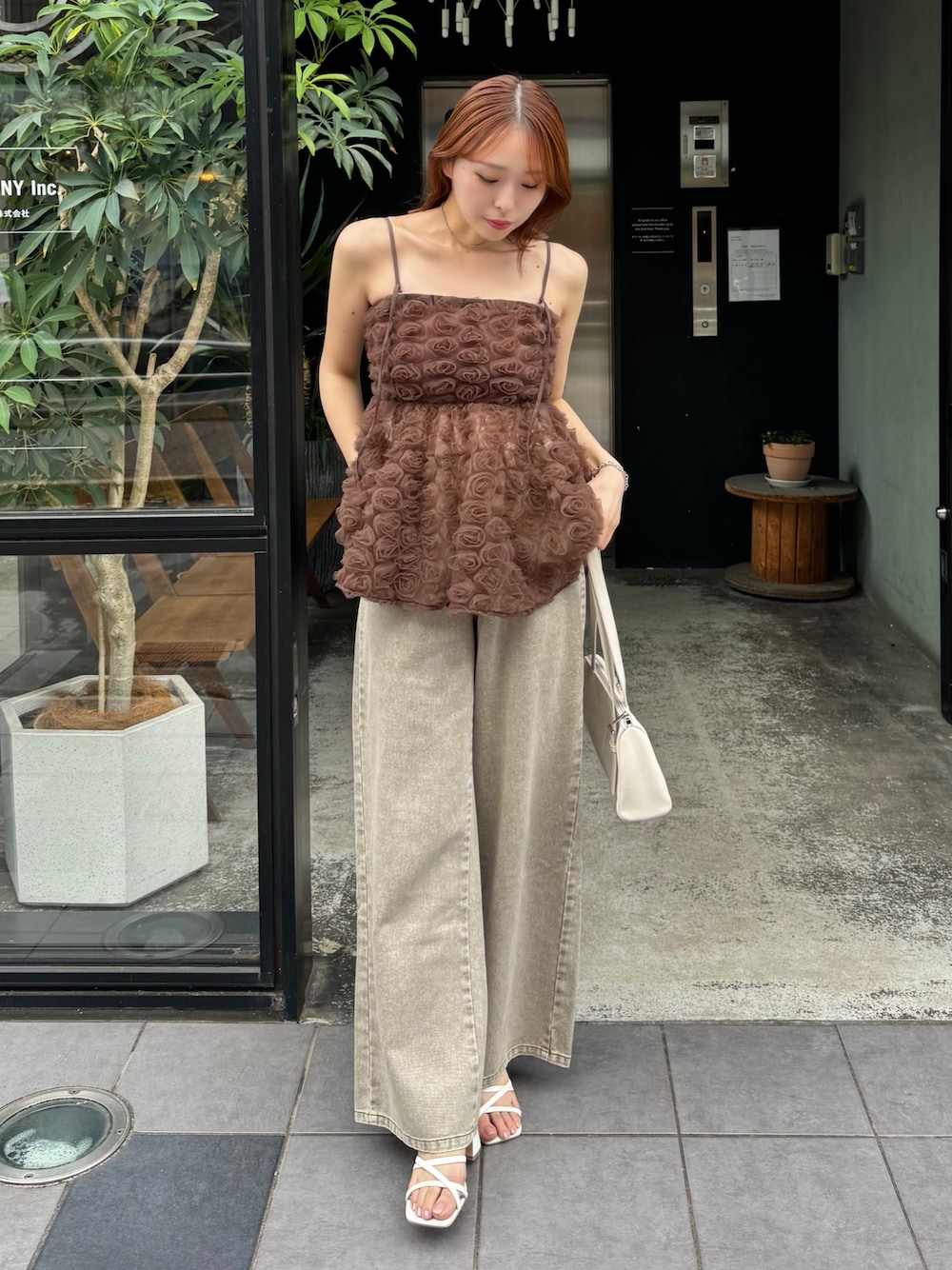 ブラウン系のシャツ/ブラウス、ホワイト系のボストンバッグ、ブラウン系のデニムパンツを着用したレディースの夏コーディネートの1枚目の写真