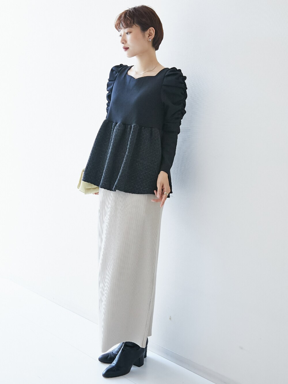 ブラック系のシャツ/ブラウス、ベージュ系のスカートを着用したレディースの秋コーディネートの1枚目の写真