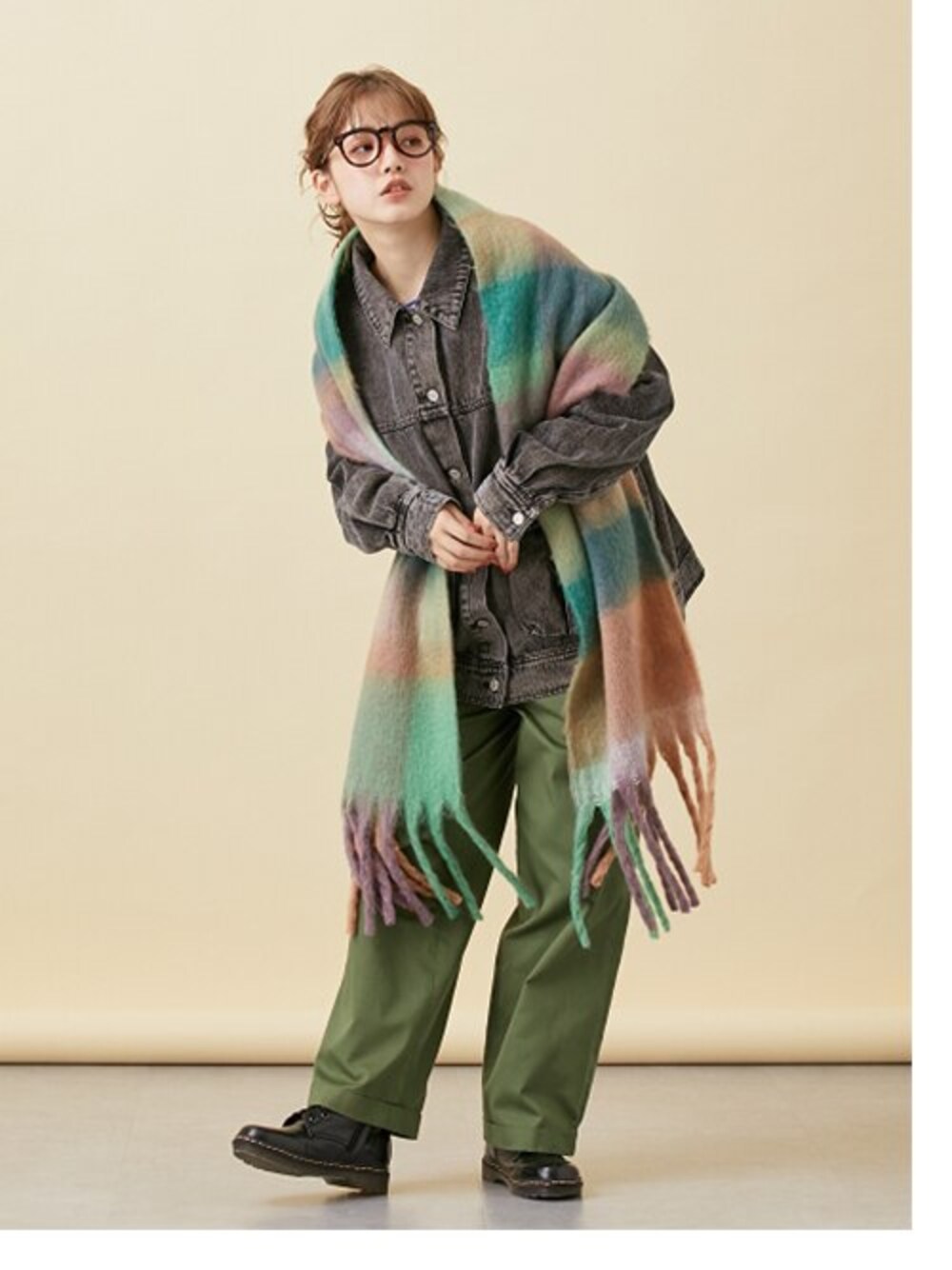 パープル系のニット/セーター、ブラック系のデニムジャケット、グリーン系のチノパンツを着用したレディースの秋コーディネートの1枚目の写真