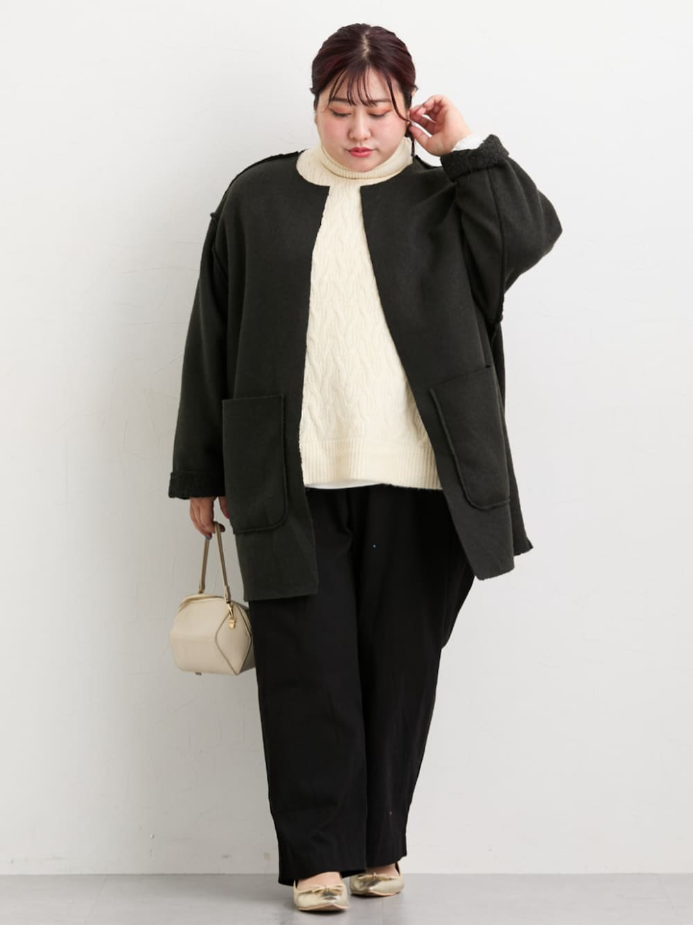 ブラック系のジャケット/アウター、ブラック系のパンツ、ベージュ系のニット/セーターを着用したレディースの秋コーディネートの1枚目の写真