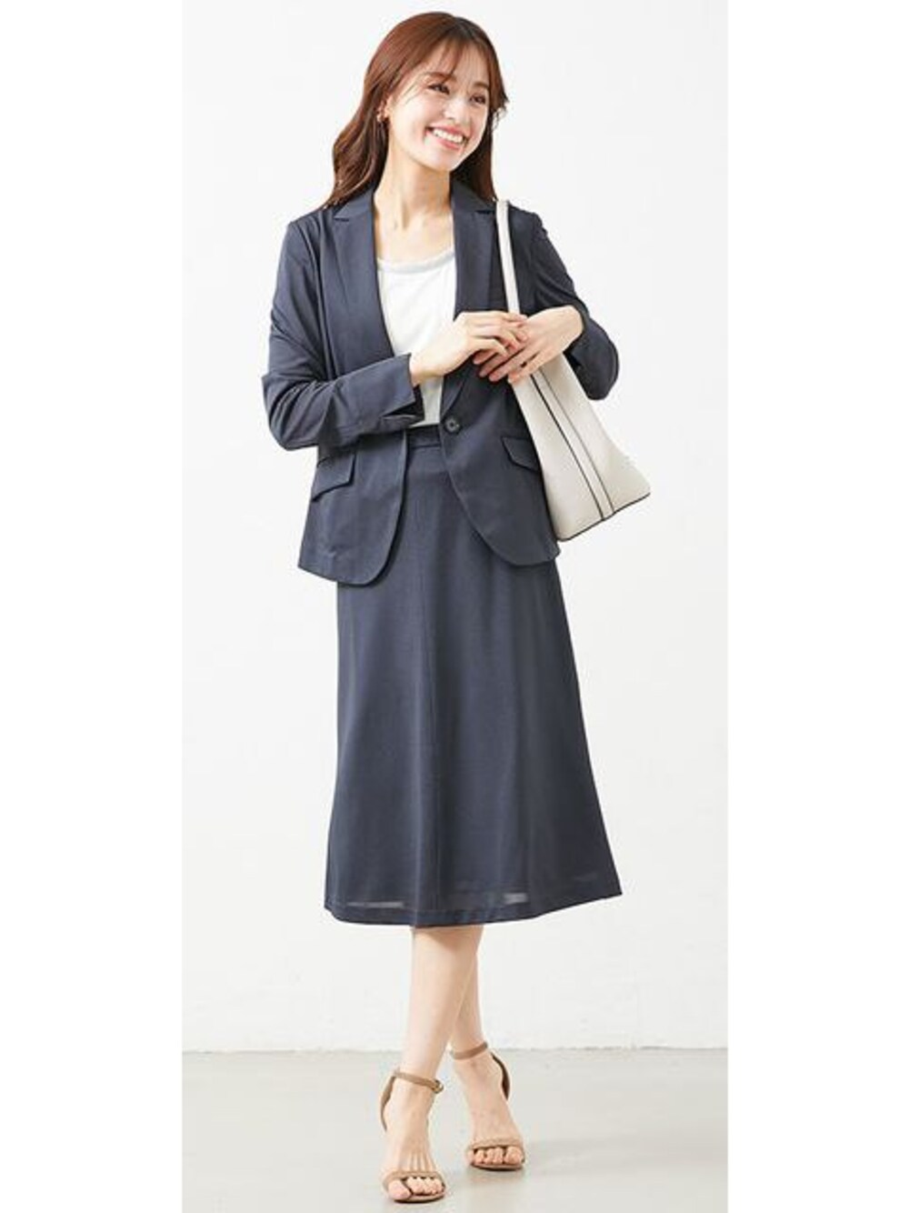 ブルー系のスーツセットを着用したレディースの春コーディネートの1枚目の写真