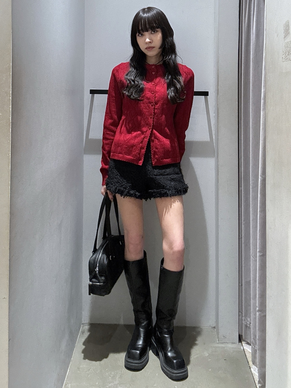 レッド系のカーディガン/ボレロ、ブラック系のスラックス、ブラック系のショルダーバッグを着用したレディースの秋コーディネートの1枚目の写真
