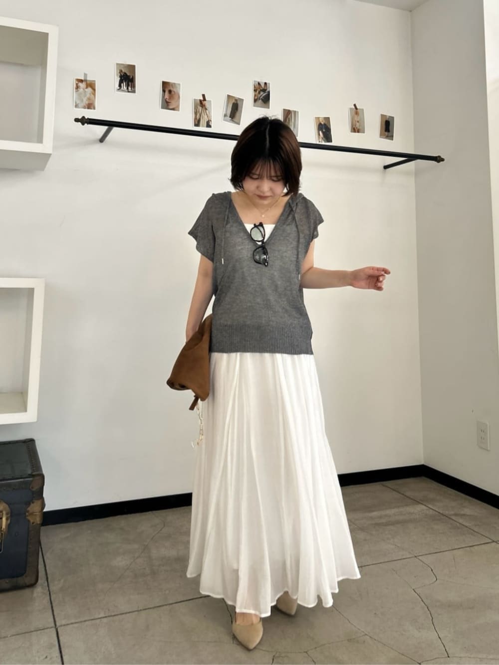 ホワイト系のキャミソール、グレー系のニット/セーターを着用したレディースの夏コーディネートの1枚目の写真