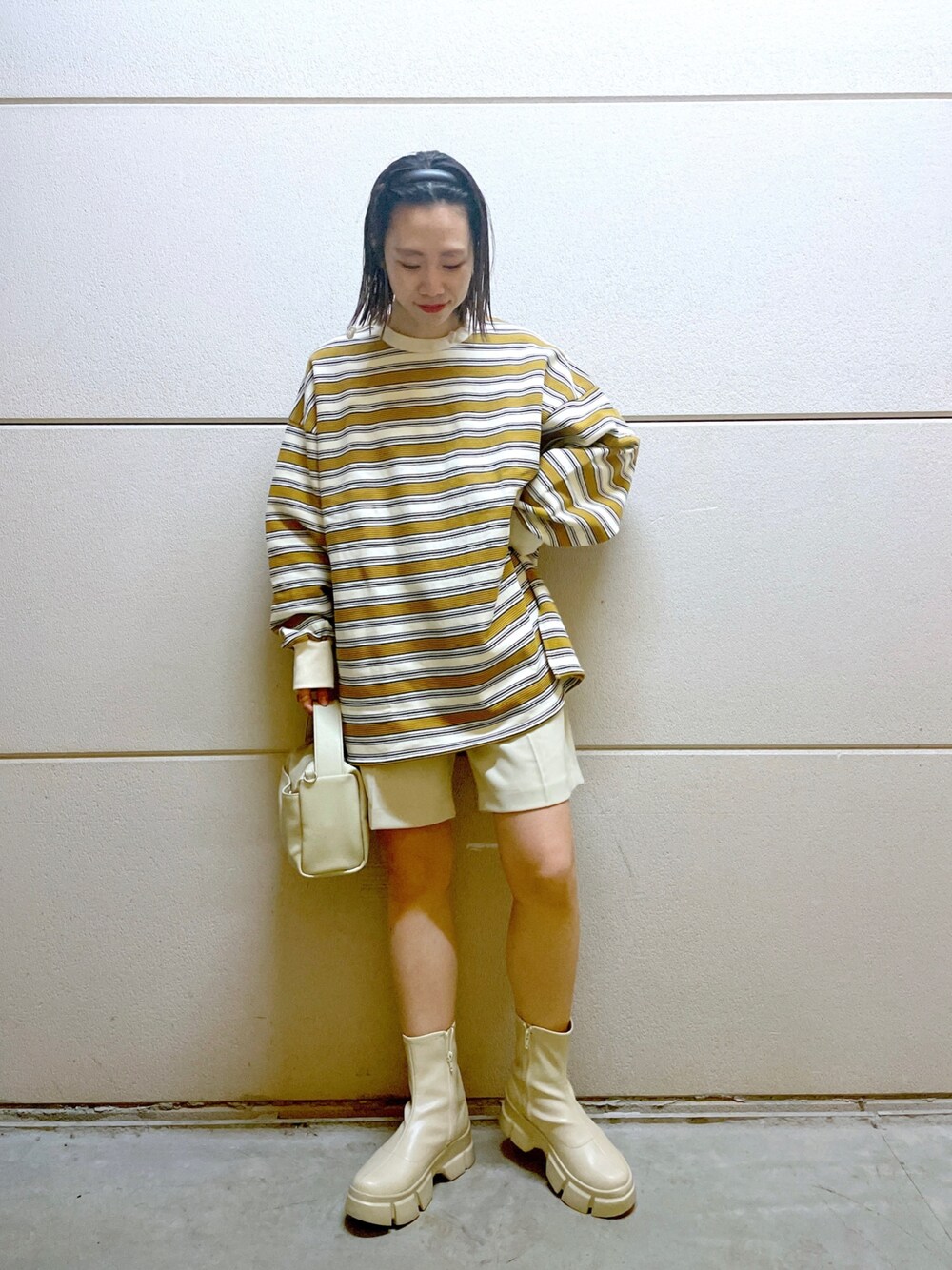 イエロー系のニット/セーター、ホワイト系のスウェット、ホワイト系のその他パンツを着用したレディースの冬コーディネートの4枚目の写真