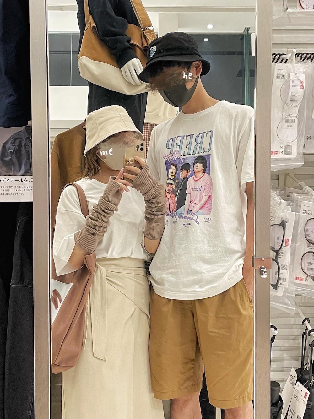 ブラウン系のトートバッグ、ベージュ系のスカート、ブラウン系のアームカバーを着用したレディースの秋コーディネートの1枚目の写真