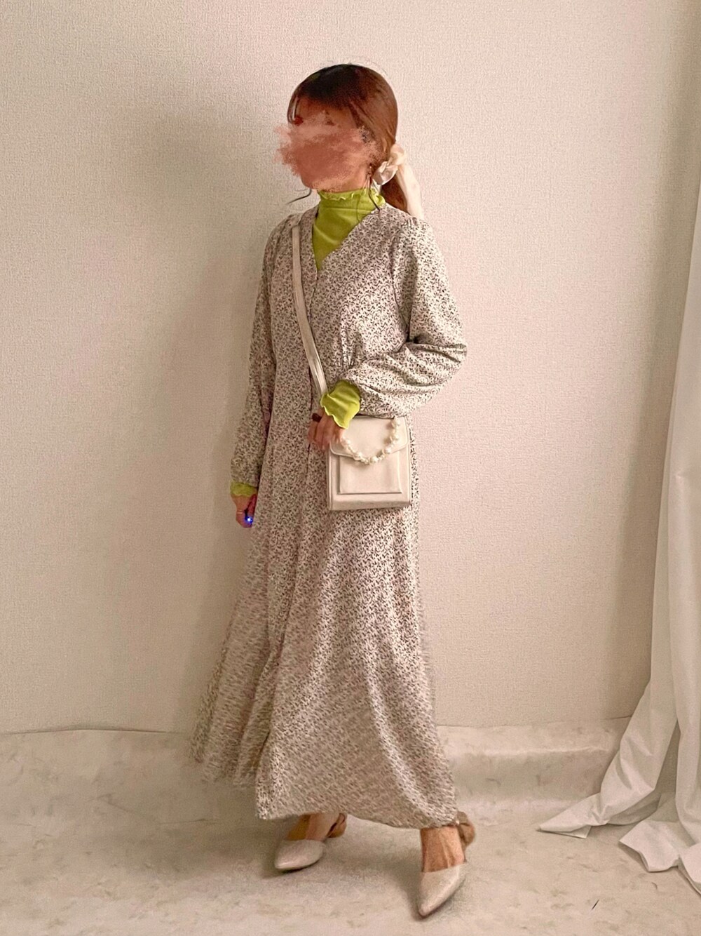 グリーン系のTシャツ/カットソー、ベージュ系のワンピース、ホワイト系のパンプスを着用したレディースの春コーディネートの1枚目の写真