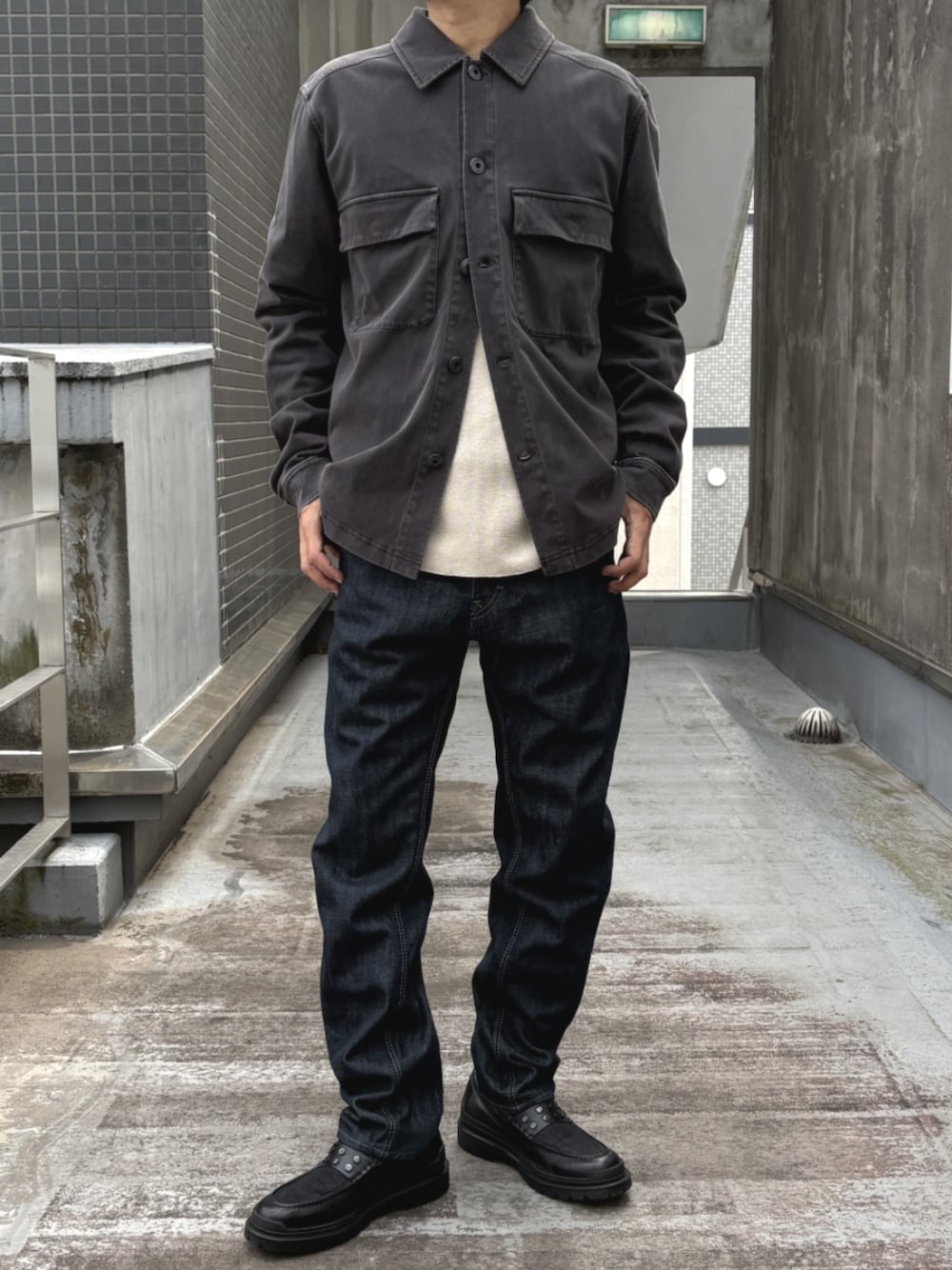 ブラック系のローファー、ホワイト系のTシャツ/カットソー、ブルー系のデニムパンツを着用したメンズの秋コーディネートの1枚目の写真