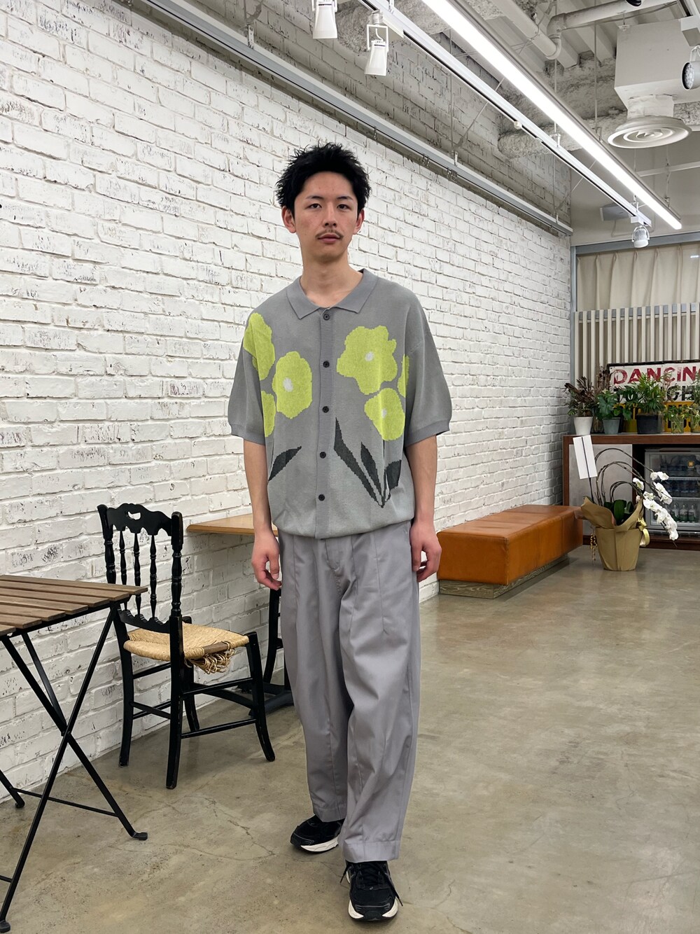 オレンジ系のカーディガン/ボレロ、ベージュ系のチノパンツを着用したメンズの春コーディネートの1枚目の写真