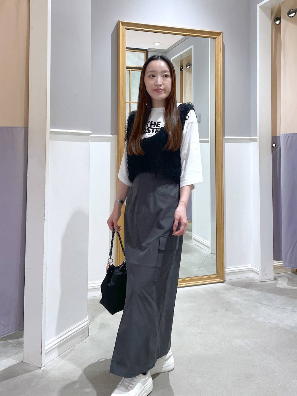 ホワイト系のTシャツ/カットソー、ブラック系のショルダーバッグ、グレー系のスカートを着用したレディースの秋コーディネートの1枚目の写真