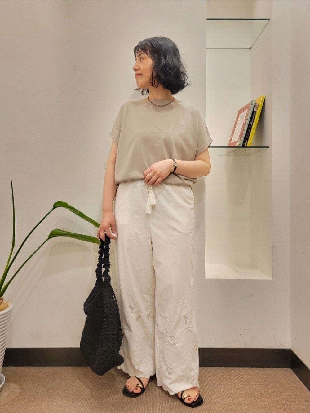 グレー系のTシャツ/カットソー、ホワイト系のその他パンツ、ブラック系のショルダーバッグを着用したレディースの夏コーディネートの1枚目の写真