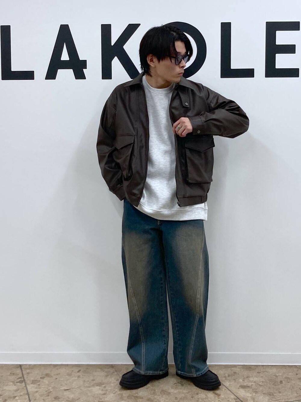 ブルー系のデニムパンツ、グレー系のスウェット、ブラック系のローファーを着用したメンズの冬コーディネートの1枚目の写真