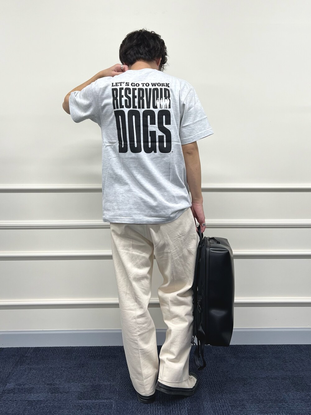 グレー系のTシャツ/カットソー、ブラック系のバックパック/リュック、ホワイト系のデニムパンツを着用したメンズの冬コーディネートの1枚目の写真