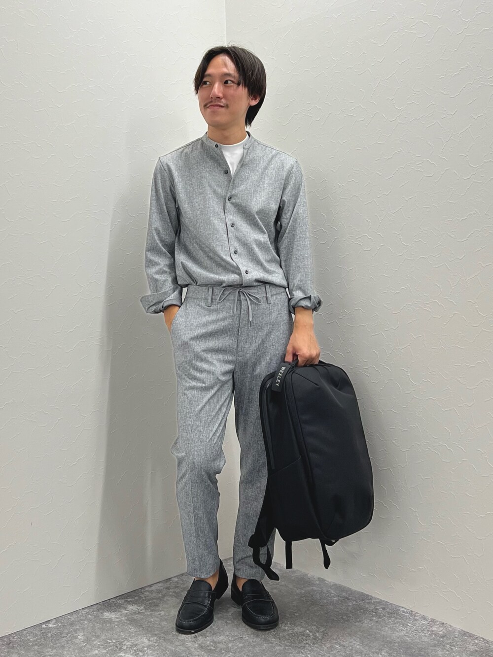 グレー系のその他パンツ、ブラック系のバックパック/リュック、グレー系のシャツ/ブラウスを着用したメンズの夏コーディネートの1枚目の写真