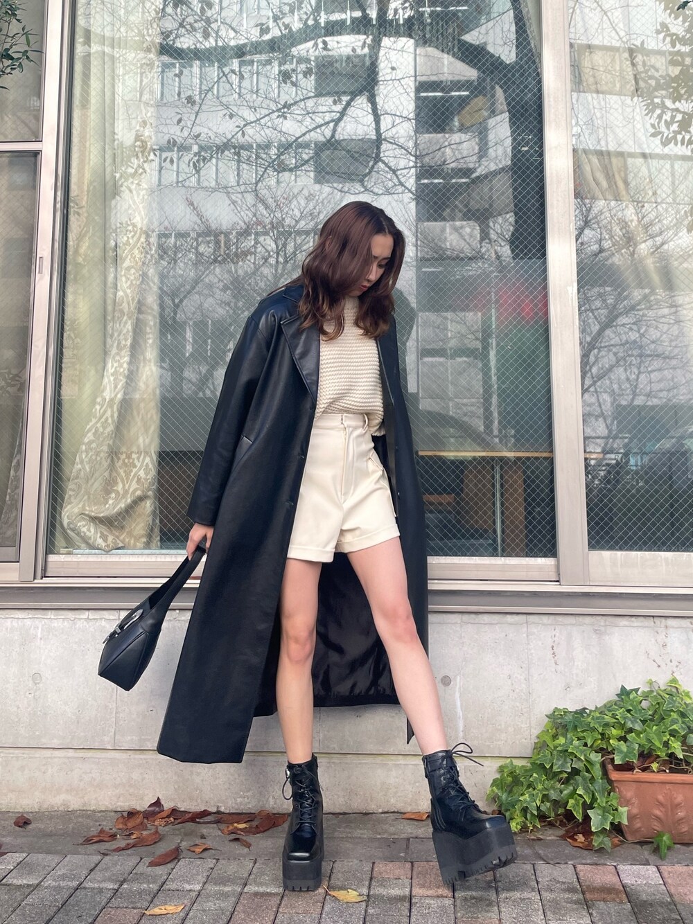 ホワイト系のニット/セーター、ホワイト系のその他パンツ、ブラック系のハンドバッグを着用したレディースの冬コーディネートの1枚目の写真