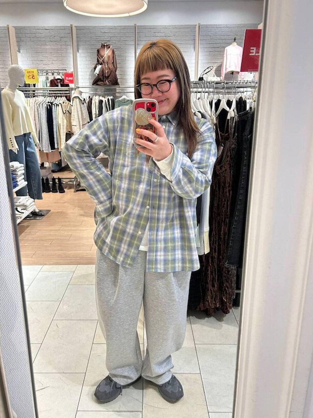 グリーン系のシャツ/ブラウス、グレー系のスウェットパンツを着用したレディースの冬コーディネートの1枚目の写真