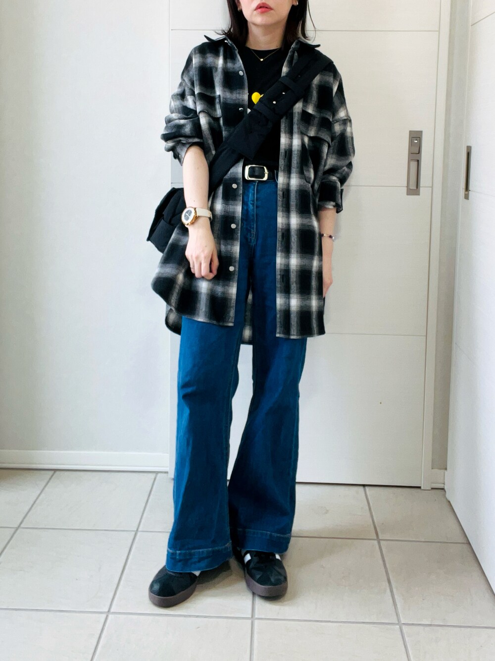 ブラック系のスニーカー、ブラック系のシャツ/ブラウス、ブラック系のTシャツ/カットソーを着用したレディースの秋コーディネートの1枚目の写真