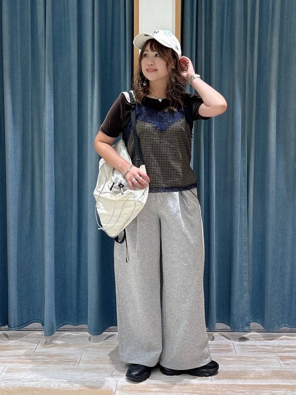 ブラック系のスニーカー、イエロー系のキャミソール、グレー系のスウェットパンツを着用したレディースの夏コーディネートの1枚目の写真