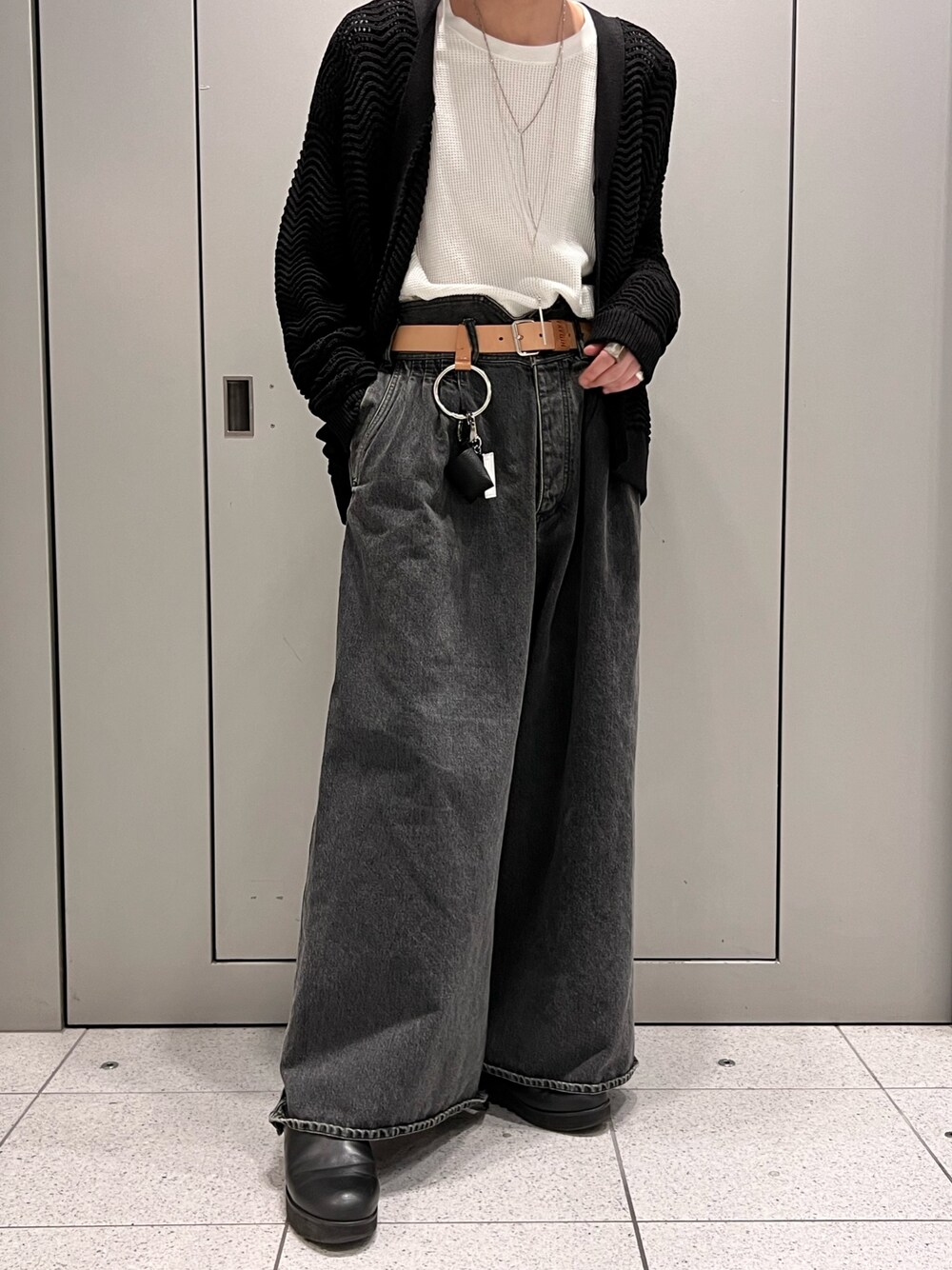 ブラック系のニット/セーター、グレー系のパンツ、ブラック系のハットを着用したメンズの春コーディネートの4枚目の写真