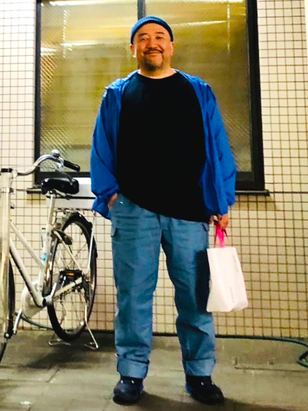 ブルー系のカーゴパンツ、ブルー系のスニーカーを着用したメンズの春コーディネートの1枚目の写真