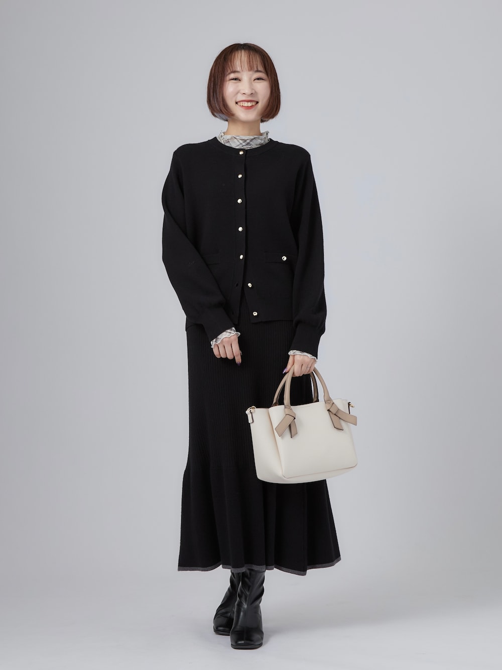 ブラック系のカーディガン/ボレロ、グレー系のTシャツ/カットソー、ブラック系のブーツを着用したレディースの秋コーディネートの1枚目の写真