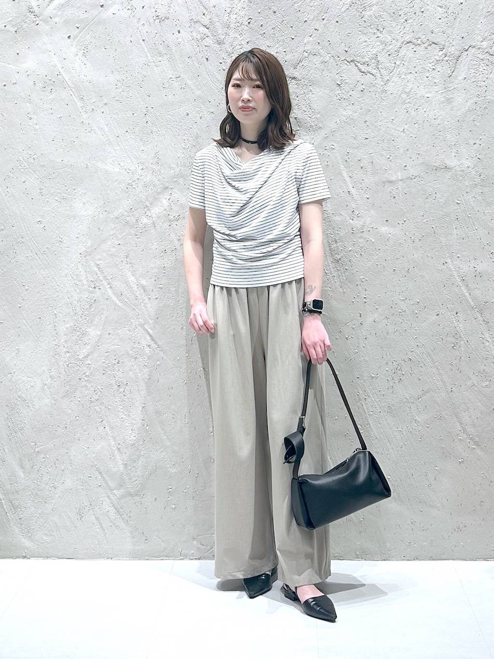ベージュ系のその他パンツ、ホワイト系のTシャツ/カットソー、ブラック系のサンダルを着用したレディースの夏コーディネートの1枚目の写真