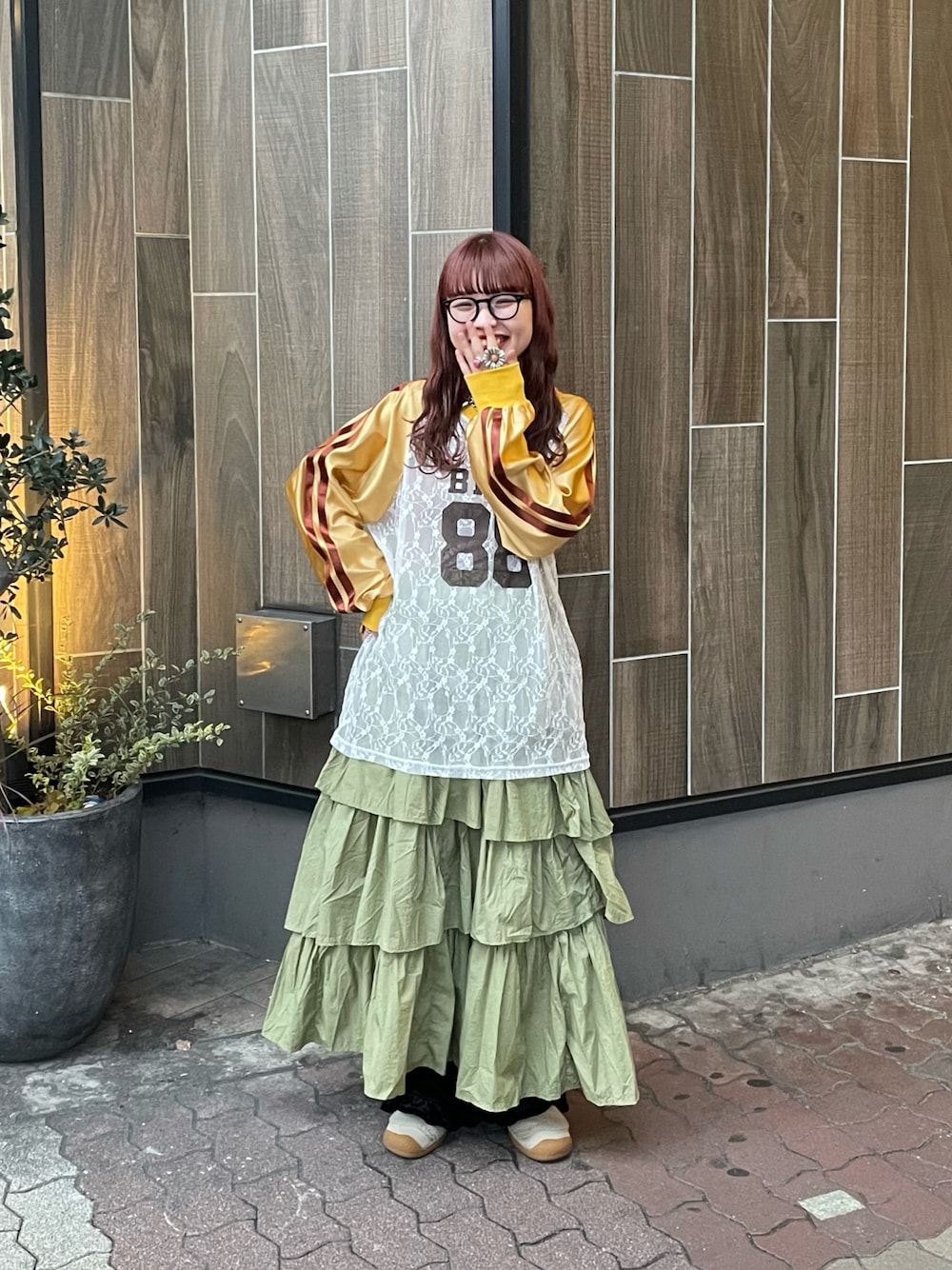 グリーン系のスカート、イエロー系のTシャツ/カットソーを着用したレディースの冬コーディネートの1枚目の写真