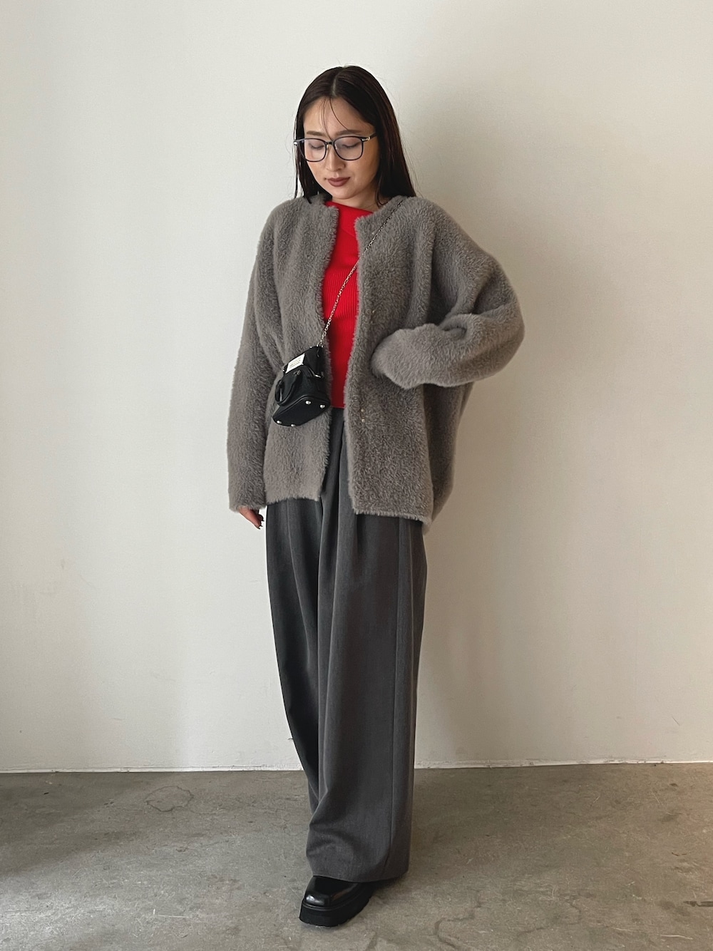 ブラック系のローファー、グレー系のその他パンツ、レッド系のニット/セーターを着用したレディースの秋コーディネートの1枚目の写真