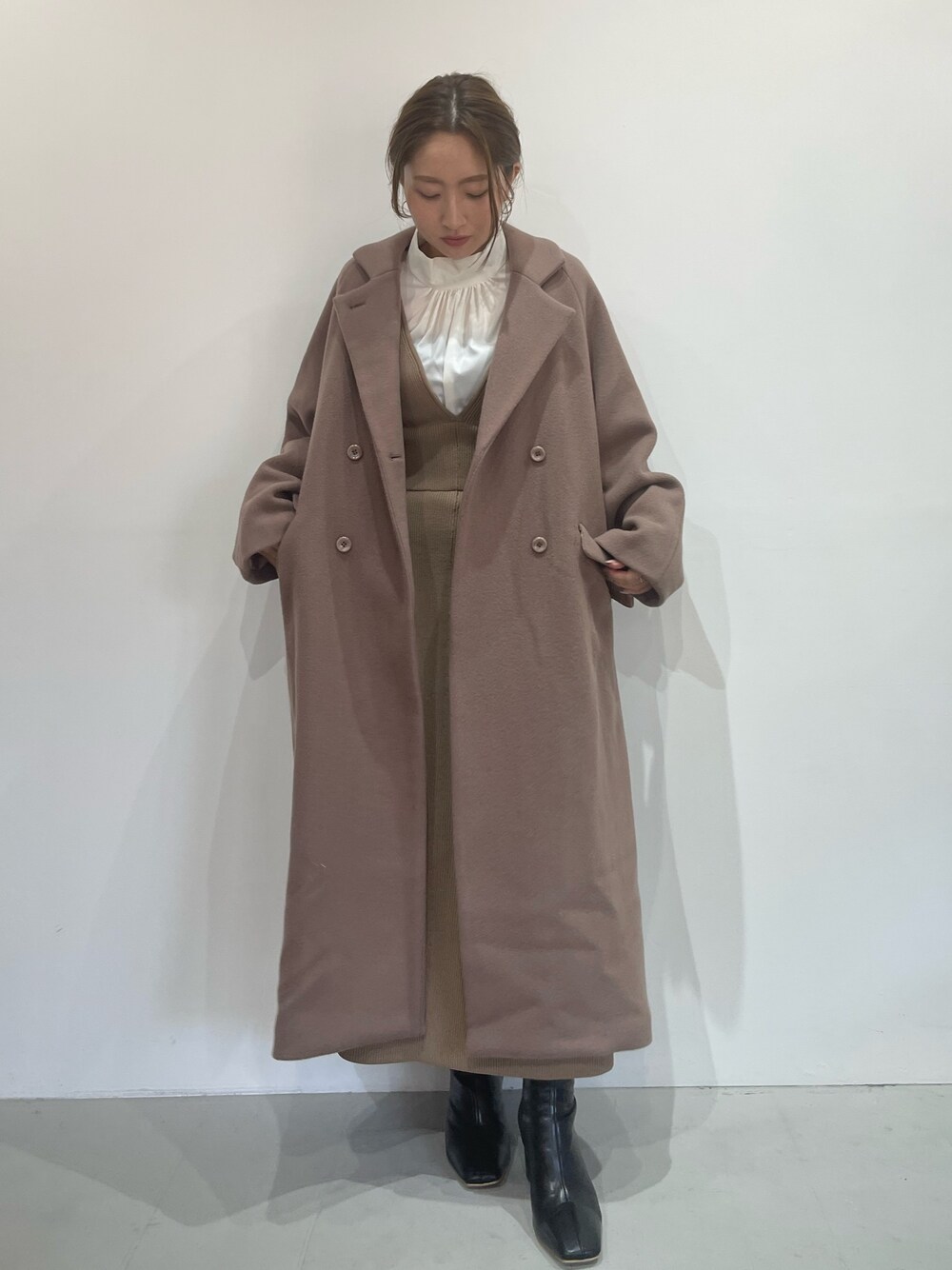 ベージュ系のジャンパースカート、ホワイト系のシャツ/ブラウス、ブラック系のブーツを着用したレディースの秋コーディネートの1枚目の写真