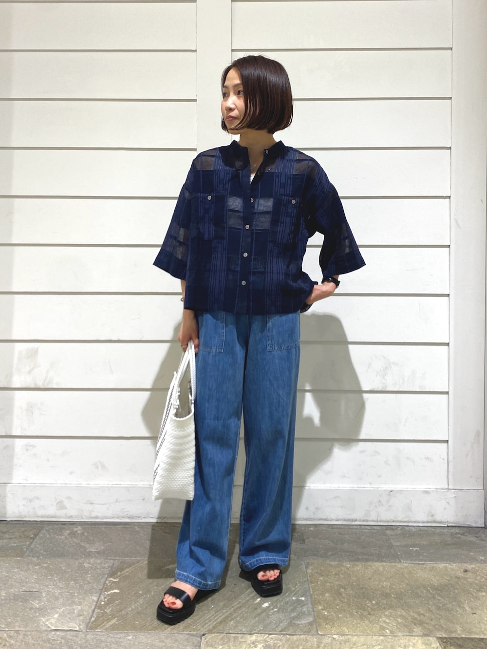 ブルー系のデニムパンツ、ブルー系のシャツ/ブラウス、ホワイト系のタンクトップを着用したレディースの夏コーディネートの1枚目の写真