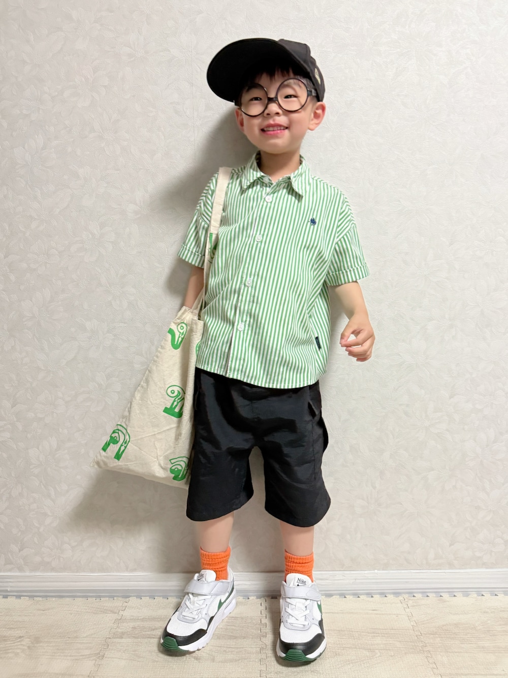グリーン系のシャツ/ブラウス、ブラック系のカーゴパンツ、ホワイト系のスニーカーを着用したキッズの春コーディネートの1枚目の写真