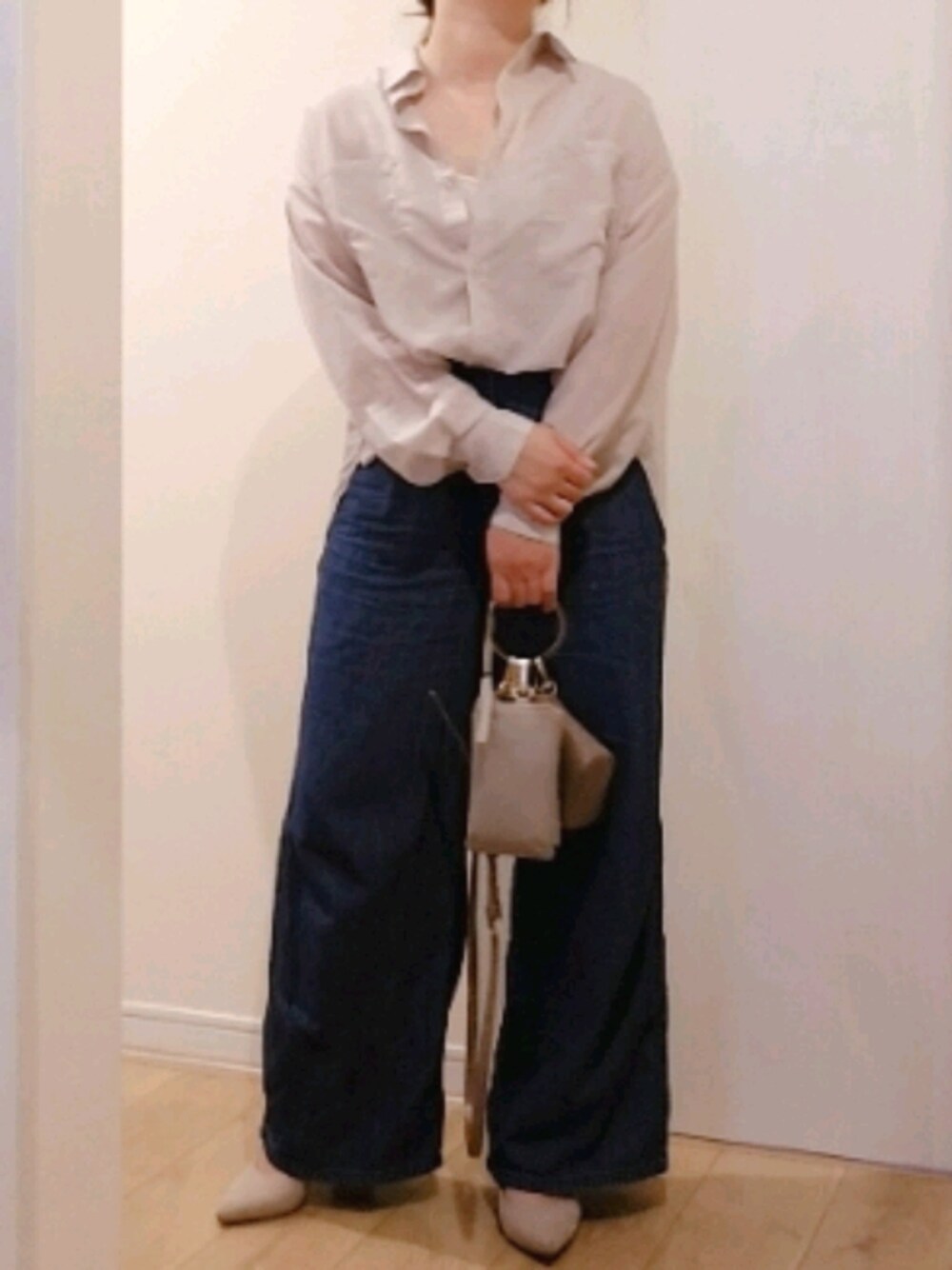 ベージュ系のシャツ/ブラウス、ブルー系のデニムパンツ、ベージュ系のバッグを着用したレディースの秋コーディネートの1枚目の写真