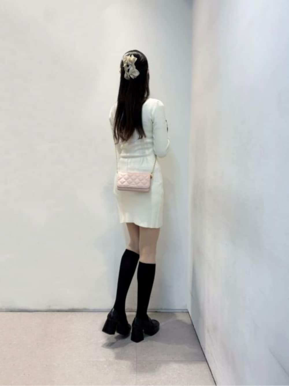 ブラック系のローファー、ピンク系の財布を着用したレディースの冬コーディネートの1枚目の写真