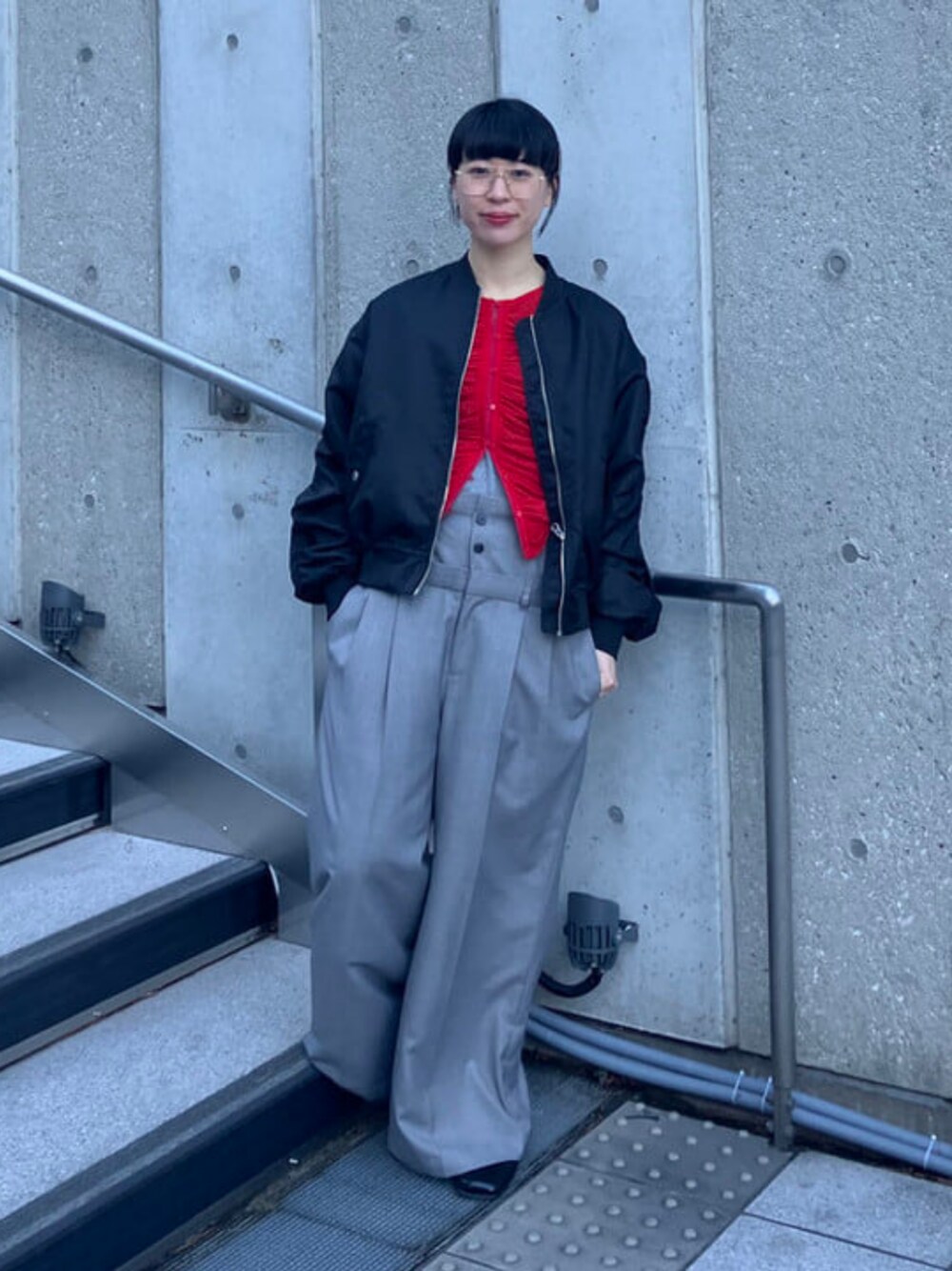 レッド系のカーディガン/ボレロ、ブラック系のMA-1、グレー系のその他パンツを着用したレディースの冬コーディネートの1枚目の写真