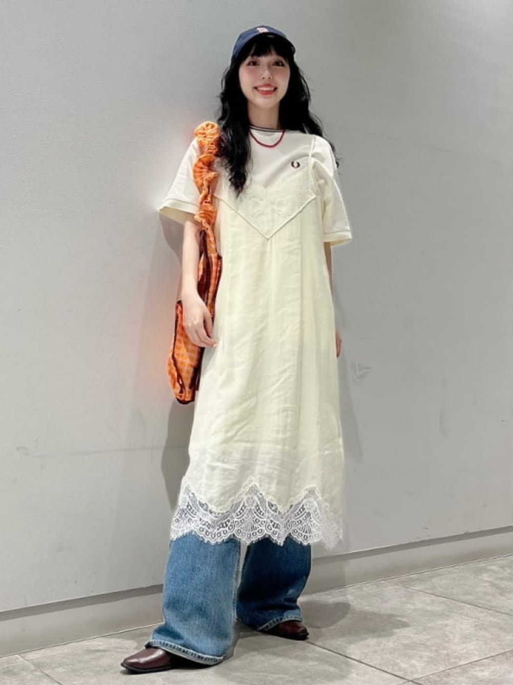 ベージュ系のTシャツ/カットソー、ホワイト系のワンピース、オレンジ系のトートバッグを着用したレディースの夏コーディネートの1枚目の写真