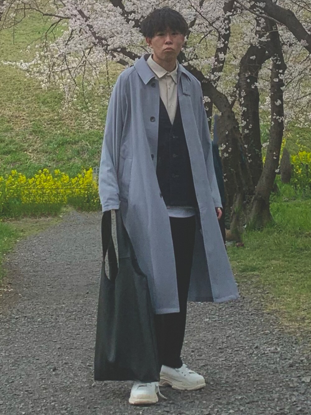 ブルー系のステンカラーコート、ホワイト系のシャツ/ブラウス、ブルー系のベストを着用したメンズの春コーディネートの1枚目の写真