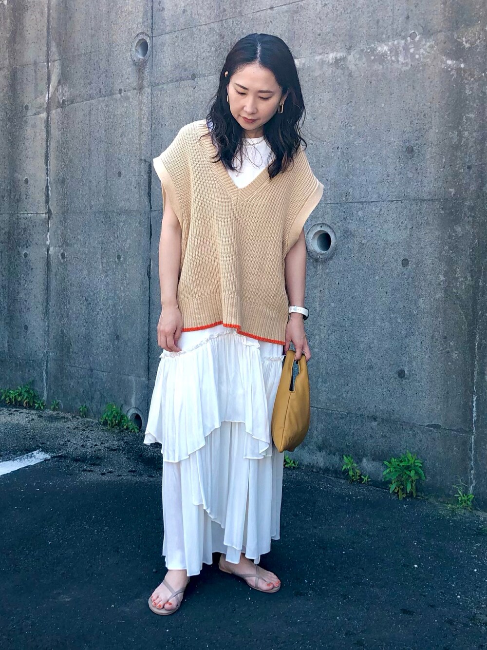 ホワイト系のTシャツ/カットソー、ホワイト系のスカート、イエロー系のショルダーバッグを着用したレディースの春コーディネートの1枚目の写真