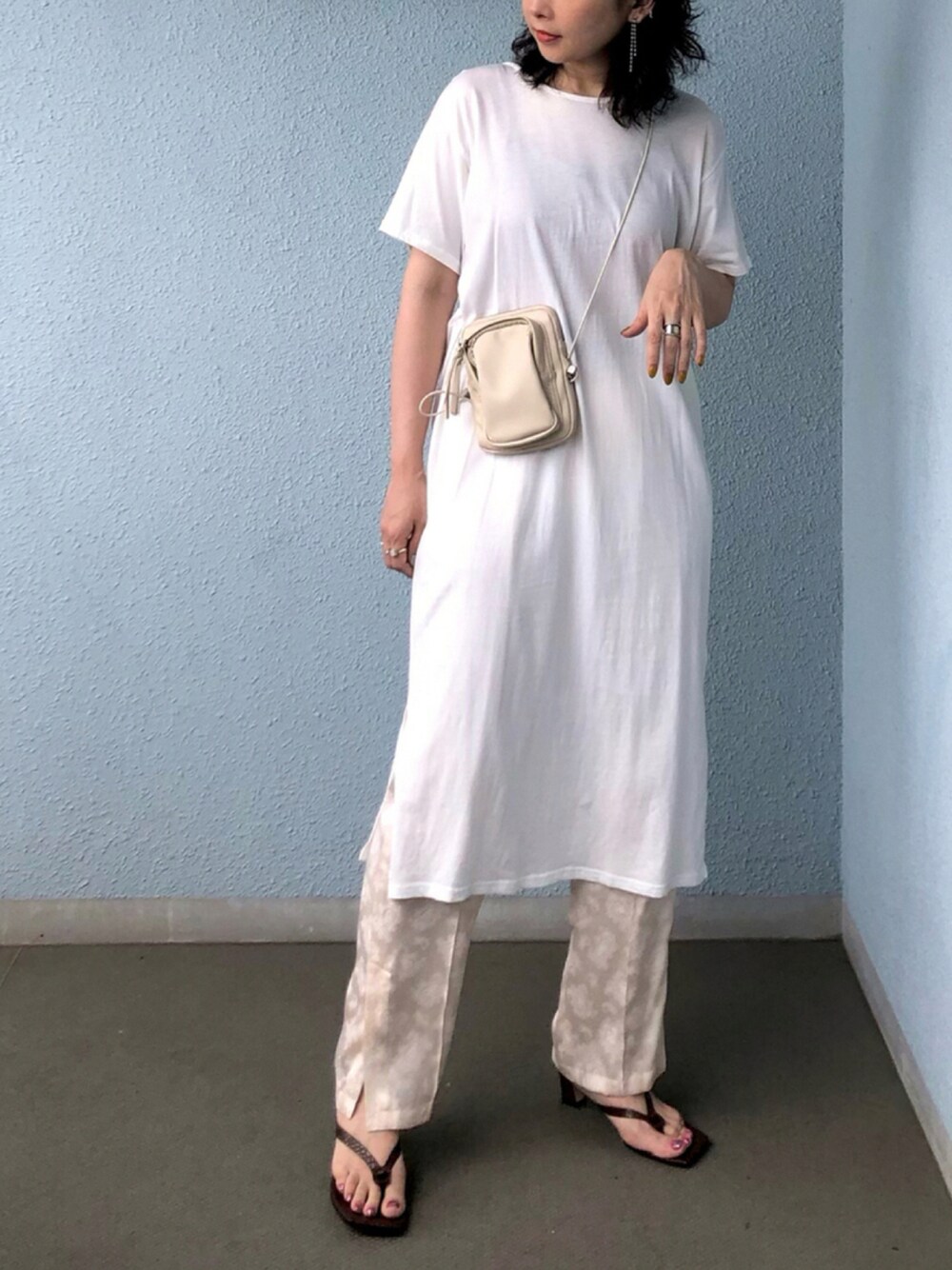 ホワイト系のワンピース、ホワイト系のその他パンツ、ブラウン系のサンダルを着用したレディースの夏コーディネートの1枚目の写真