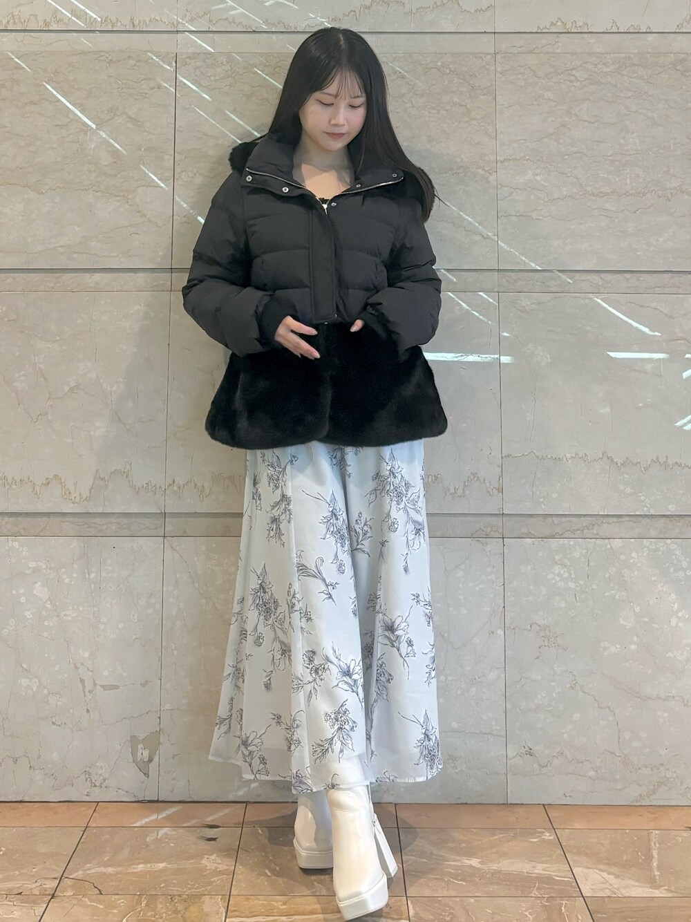 ブラック系のワンピース、ホワイト系のブーツ、ブラック系のその他アウターを着用したレディースの秋コーディネートの1枚目の写真