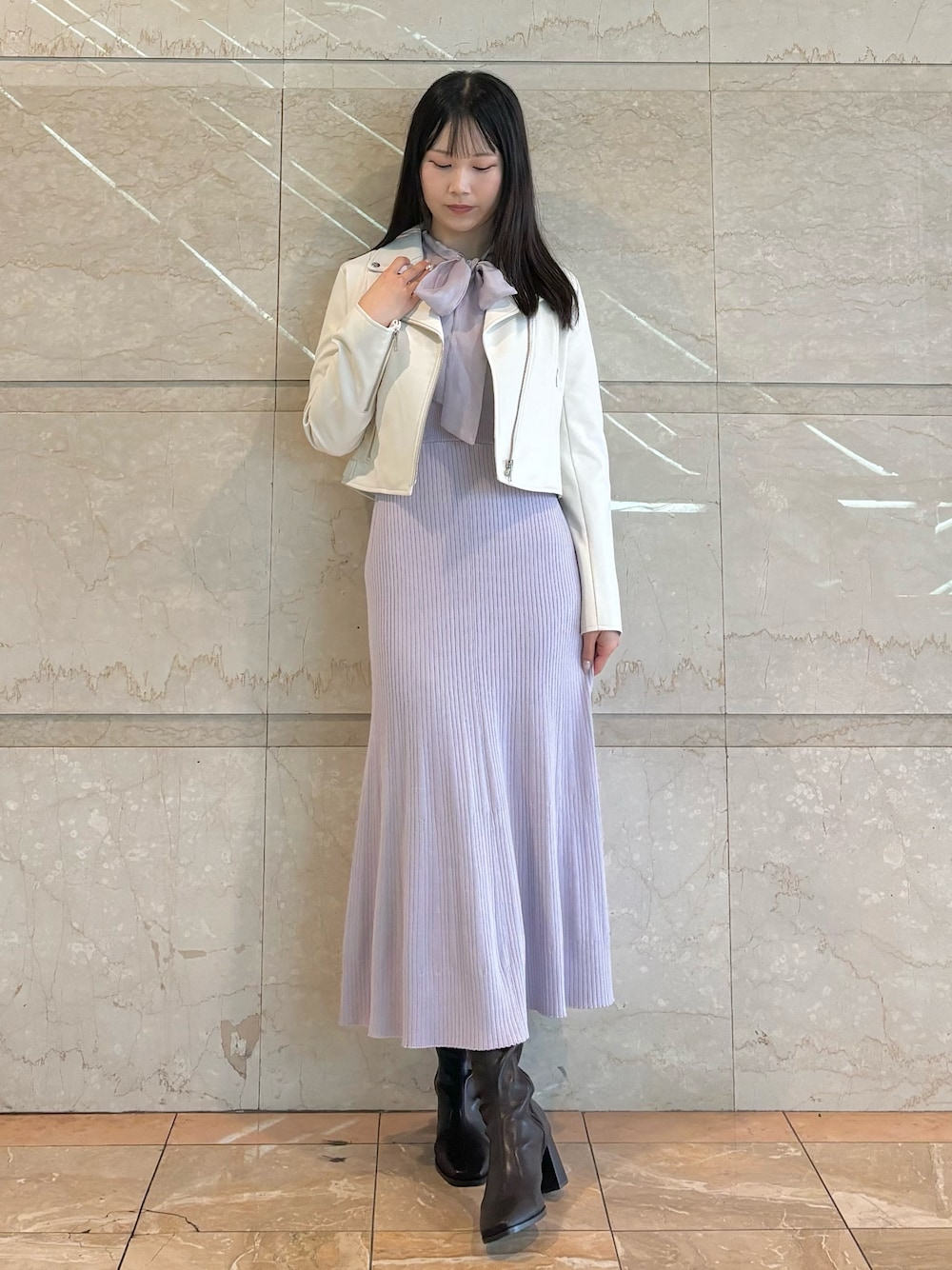 パープル系のワンピース、ホワイト系のライダースジャケット、ブラウン系のブーツを着用したレディースの秋コーディネートの1枚目の写真