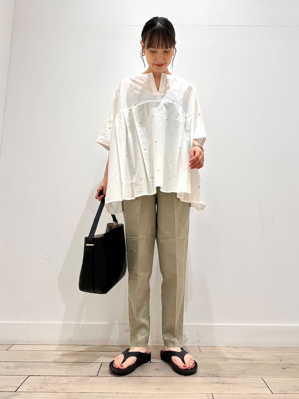 グリーン系のその他パンツ、ブラック系のバレエシューズ、ブラック系のハンドバッグを着用したレディースの夏コーディネートの1枚目の写真