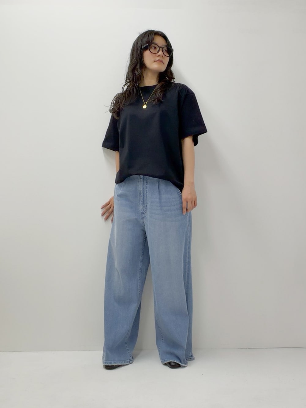 ブルー系のデニムパンツ、ブラック系のTシャツ/カットソーを着用したレディースの夏コーディネートの1枚目の写真