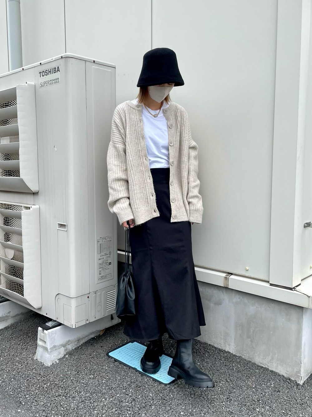 ホワイト系のTシャツ/カットソー、ブラック系のスカート、ブラック系のショルダーバッグを着用したレディースの秋コーディネートの1枚目の写真