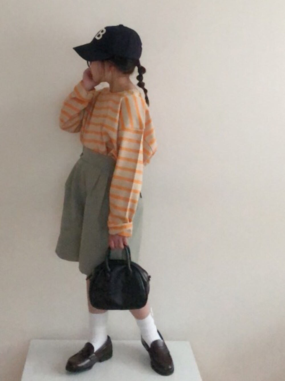 グリーン系のその他パンツ、オレンジ系のTシャツ/カットソー、ブルー系のキャップを着用したキッズの春コーディネートの1枚目の写真